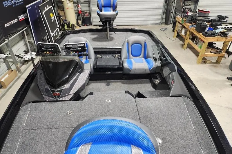 Slide: The Image of 2024 Ranger Z519 boat interior with blue seats and advanced navigation equipment. - 6