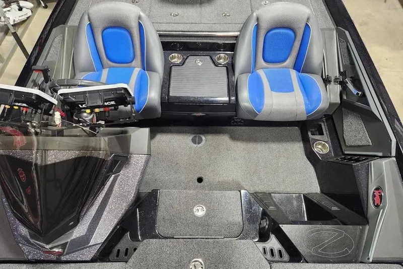 Slide: The Image of 2024 Ranger Z519 boat interior with dual blue and gray seats, advanced controls, and carpeted flooring. - 7