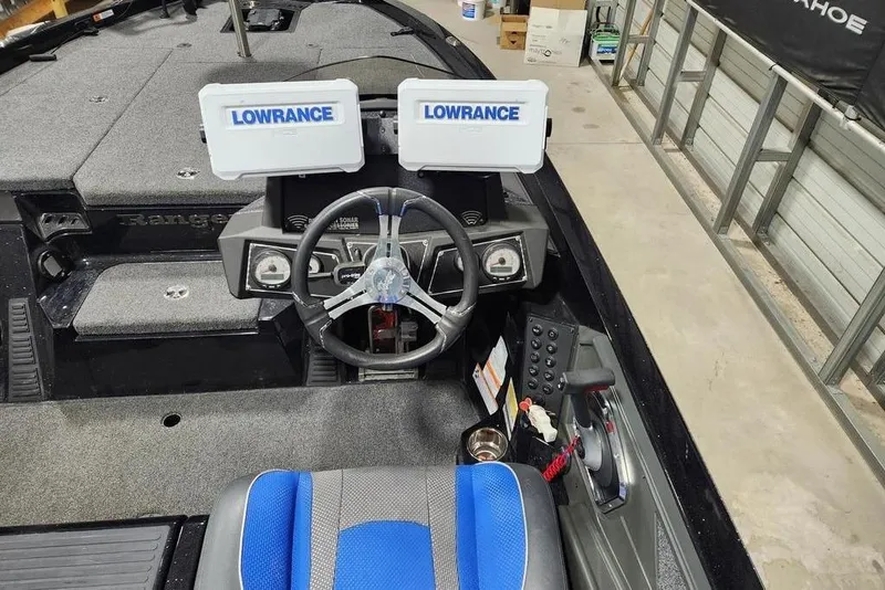 Slide: The Image of 2024 Ranger Z519 boat cockpit with dual Lowrance displays and blue seat. - 8
