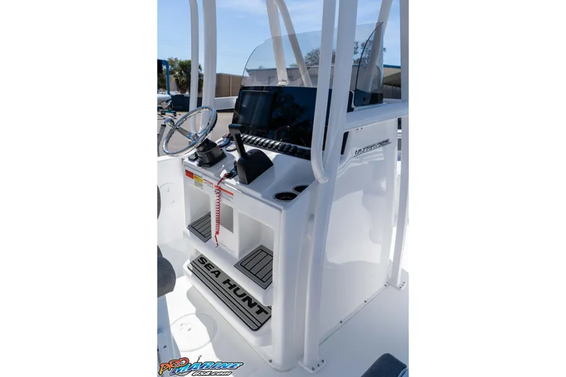 Slide: The Image of 2026 Sea Hunt Ultra 229 boat console with steering wheel and navigation display. - 14
