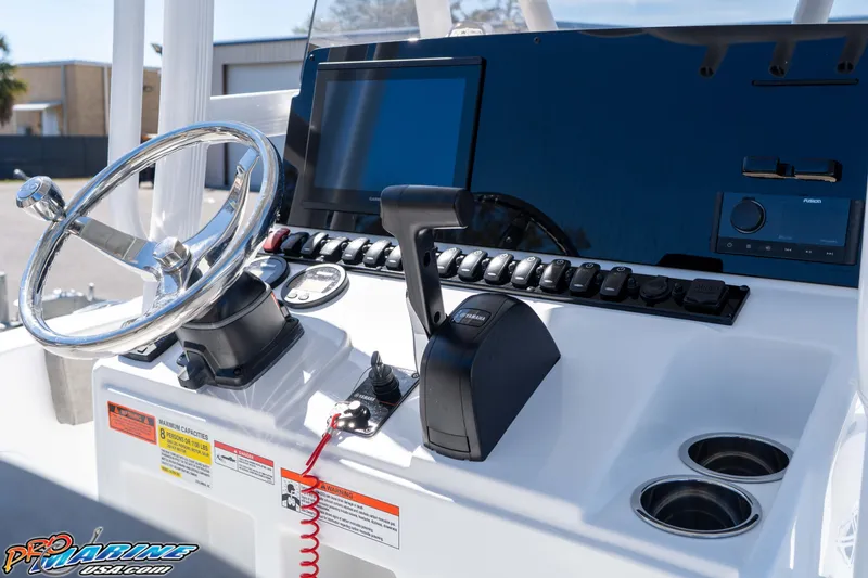 Slide: The Image of 2026 Sea Hunt Ultra 229 boat dashboard with steering wheel and control panel. - 15