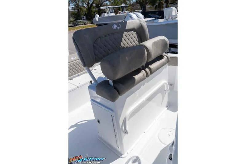 Slide: The Image of 2026 Sea Hunt Ultra 229 boat seating with cushioned backrest and storage compartment. - 17