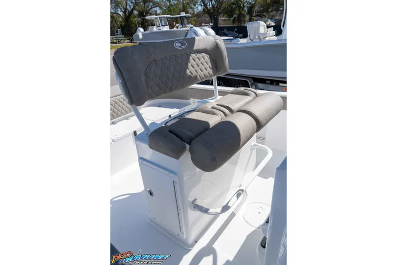 Slide: The Image of 2026 Sea Hunt Ultra 229 boat seat with gray cushioned backrest and storage compartment. - 18