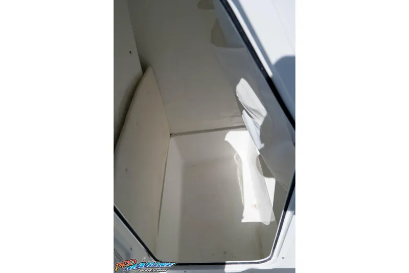 Slide: The Image of Interior storage compartment of 2026 Sea Hunt Ultra 229 boat, featuring clean white surfaces. - 22