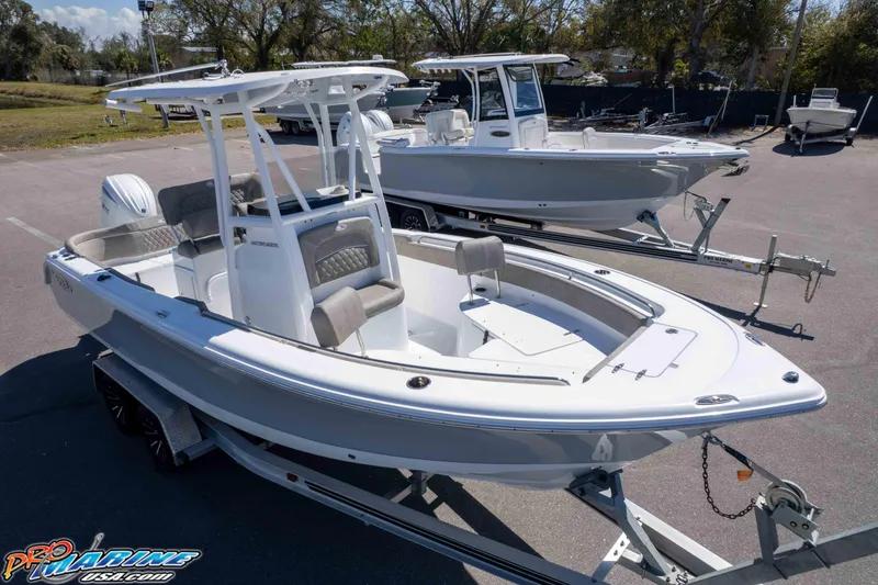 Slide: The Image of 2026 Sea Hunt Ultra 229 boat on trailer, parked outdoors, showcasing sleek design. - 24