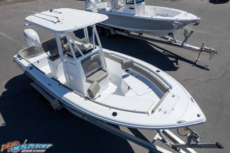 Slide: The Image of 2026 Sea Hunt Ultra 229 boat on trailer, sleek design, white exterior. - 25
