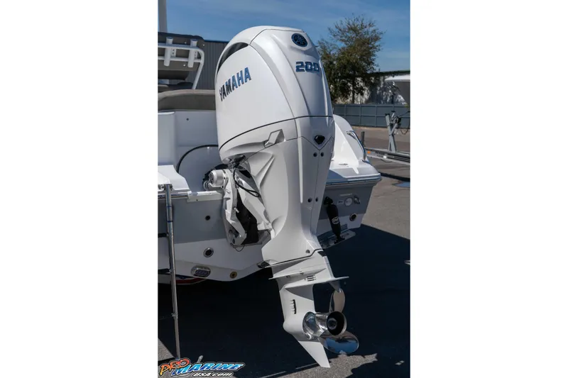 Slide: The Image of 2026 Sea Hunt Ultra 229 boat with Yamaha outboard motor, parked outdoors. - 3