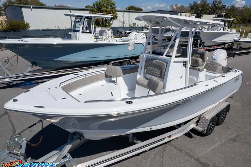 Slide: The Image of 2026 Sea Hunt Ultra 229 boat on trailer, displayed outdoors in a dealership lot. - 30