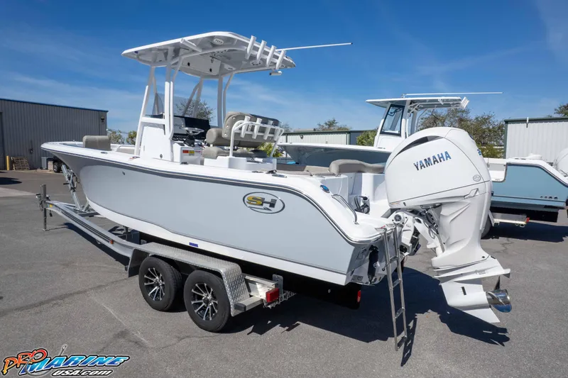 Slide: The Image of 2026 Sea Hunt Ultra 229 boat with Yamaha engine on trailer, parked outdoors. - 35