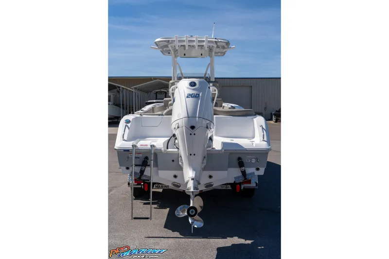 Slide: The Image of 2026 Sea Hunt Ultra 229 boat rear view with outboard motor in marina. - 4