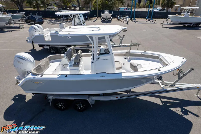 Slide: The Image of 2026 Sea Hunt Ultra 229 boat on trailer in marina setting. - 43