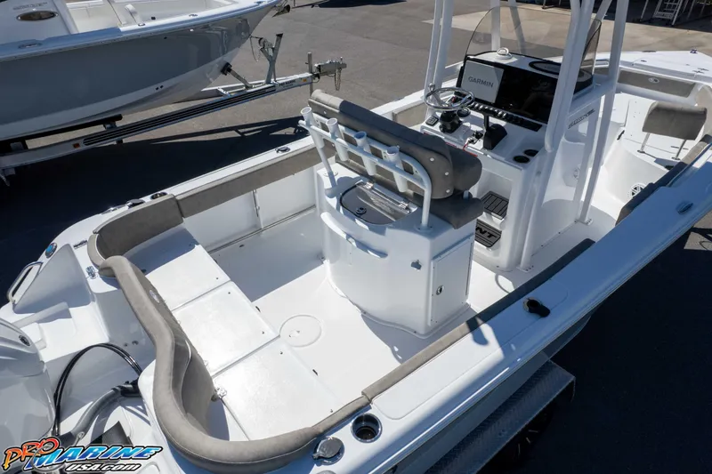 Slide: The Image of 2026 Sea Hunt Ultra 229 boat interior with seating and console, displayed outdoors. - 48