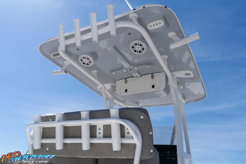 Slide: The Image of 2026 Sea Hunt Ultra 229 boat T-top with rod holders and speakers against blue sky. - 7