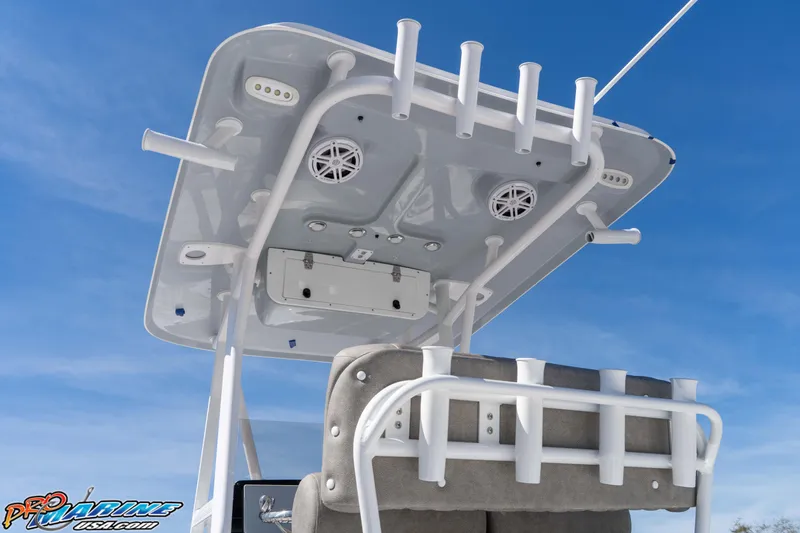 Slide: The Image of 2026 Sea Hunt Ultra 229 boat top view with rod holders and speakers against blue sky. - 9