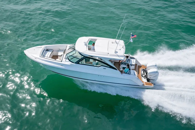 Slide: The Image of A sleek, modern motorboat speeds across clear, green water. - 1