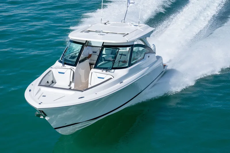 Slide: The Image of A sleek, modern motorboat speeds across the blue water. - 0