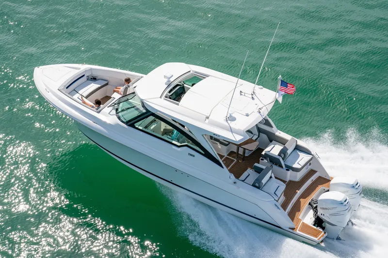 Slide: The Image of The 2027 Tiara Yachts 34lx glides elegantly over the water, featuring a sleek design and comfortable seating areas. - 2