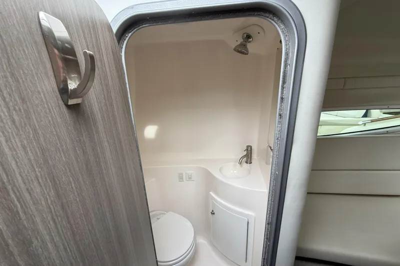 Slide: The Image of 2020 Regal 26 XO boat bathroom with shower, sink, and toilet. - 11