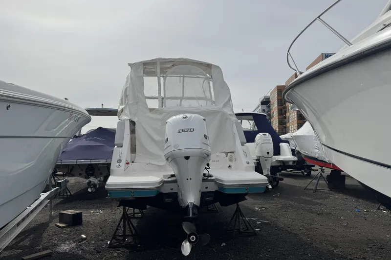 Slide: The Image of 2020 Regal 26 XO boat with Yamaha 300 outboard engine, docked among other boats. - 3
