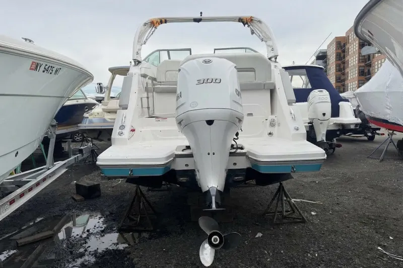 Slide: The Image of 2020 Regal 26 XO boat with Yamaha 300 engine, displayed on stands. - 4