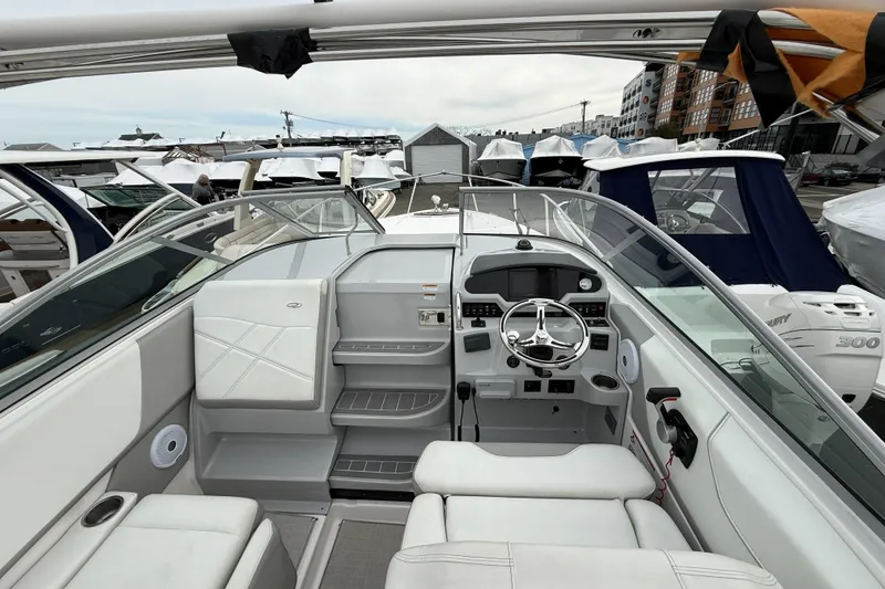 Slide: The Image of Interior view of a 2020 Regal 26 XO boat, showcasing the helm and seating area. - 7