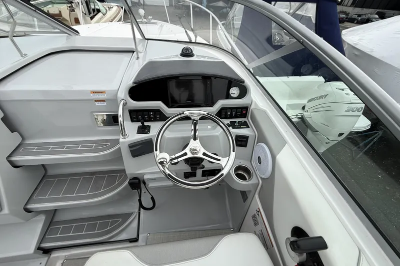 Slide: The Image of Cockpit of 2020 Regal 26 XO boat with steering wheel and control panel. - 8