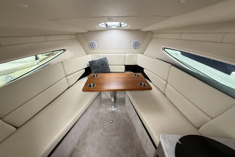 Slide: The Image of Interior of 2020 Regal 26 XO boat with beige seating and wooden table. - 9