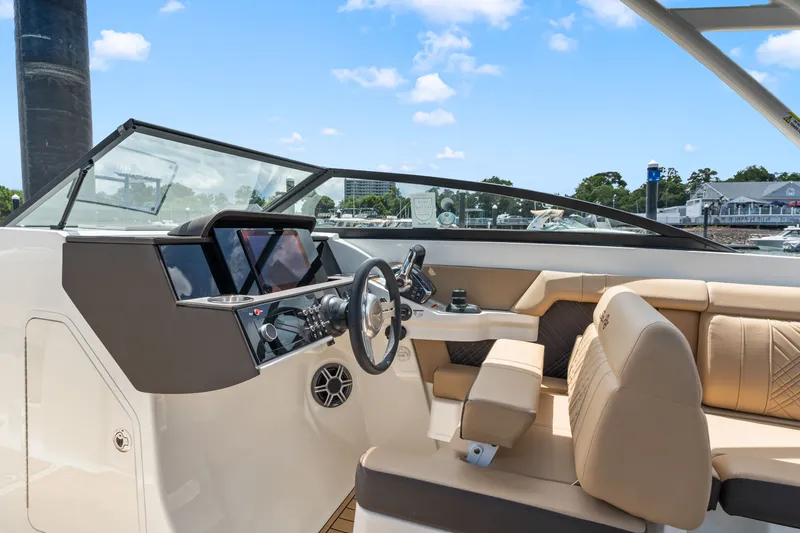 Slide: The Image of The image shows the cockpit of a 2026 Sea Ray SDX 290 Outboard with modern instruments and comfortable seating. - 15