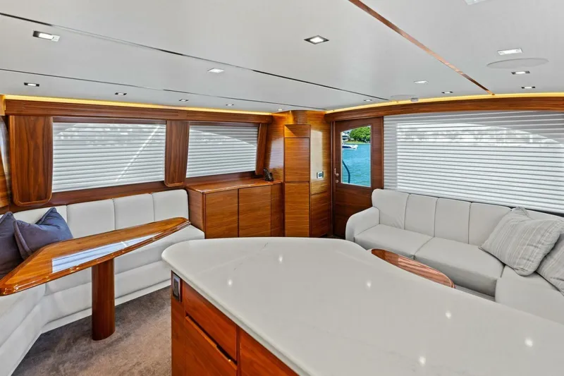 Slide: The Image of Luxurious interior of 2023 Vikiing convertible yacht with elegant wood and white seating. - 10