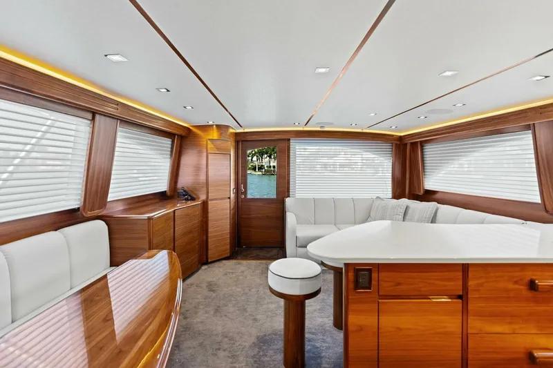 Slide: The Image of Luxurious interior of 2023 Vikiing convertible yacht with elegant wood finishes and modern seating. - 11
