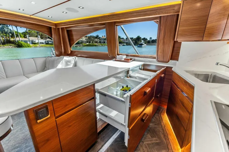 Slide: The Image of Luxurious 2023 Vikiing convertible yacht interior with modern kitchen and scenic water view. - 14
