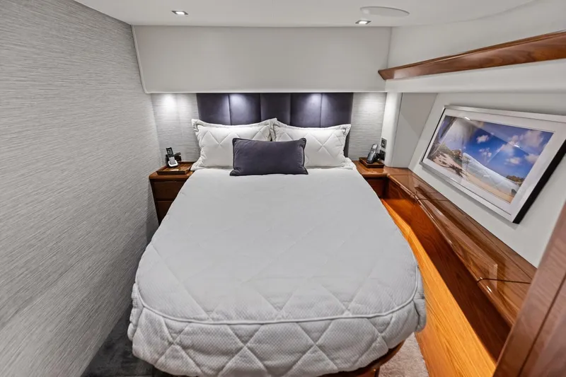Slide: The Image of Luxurious 2023 Vikiing convertible yacht bedroom with elegant bedding and modern decor. - 16