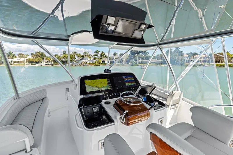 Slide: The Image of Luxurious 2023 Vikiing convertible yacht cockpit with advanced navigation system and plush seating. - 39