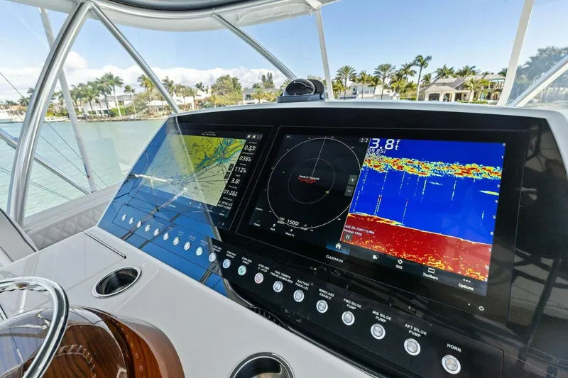 Slide: The Image of 2023 Vikiing convertible yacht dashboard with advanced navigation and sonar displays. - 42