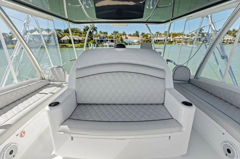 Slide: The Image of Luxurious interior of 2023 Vikiing convertible boat with plush seating and scenic water view. - 45
