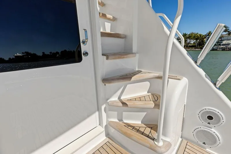 Slide: The Image of Staircase on 2023 Vikiing convertible yacht with sleek design and ocean view. - 48
