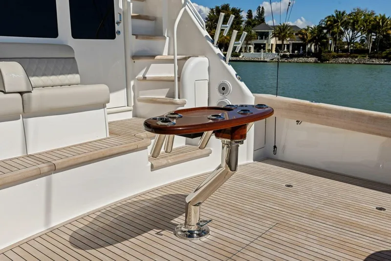 Slide: The Image of Luxurious 2023 Vikiing convertible yacht deck with elegant seating and fishing rod holders. - 52