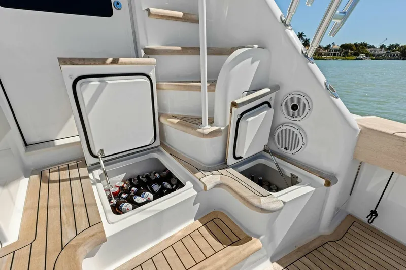 Slide: The Image of Luxury 2023 Vikiing convertible yacht with built-in coolers and elegant wooden deck. - 55