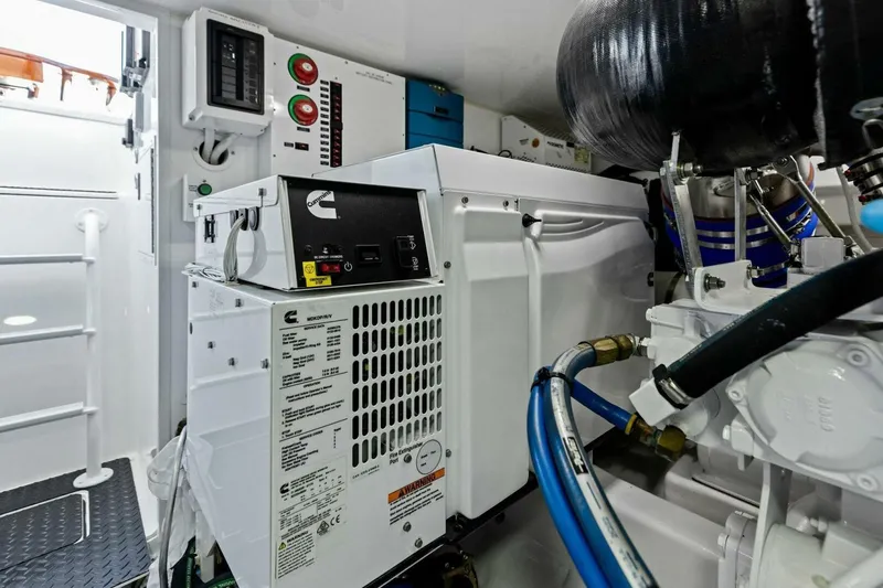 Slide: The Image of Engine room of 2023 Vikiing convertible yacht with Cummins generator and control panels. - 59
