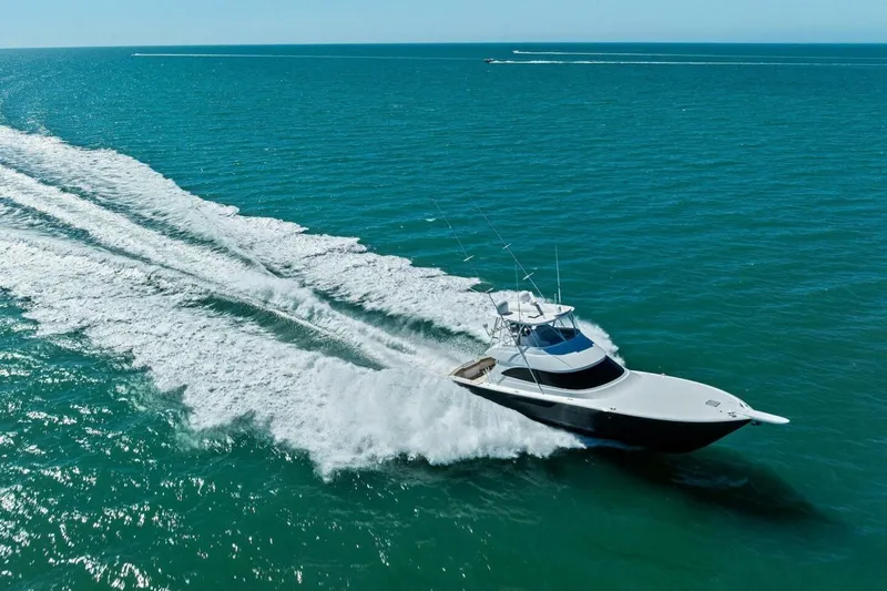 Slide: The Image of 2023 Vikiing convertible yacht cruising on open ocean waters. - 74