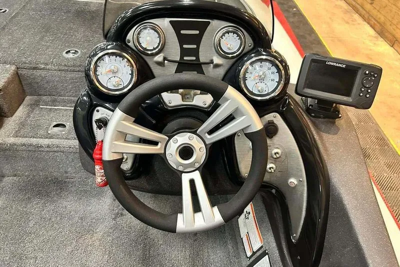 Slide: The Image of 2019 Tracker Pro Team 175 TXW Tournament Edition boat dashboard with steering wheel and gauges. - 9