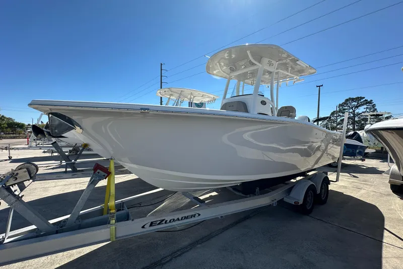 Slide: The Image of 2023 Sea Pro 239 Deep V CC boat on trailer under clear blue sky. - 1