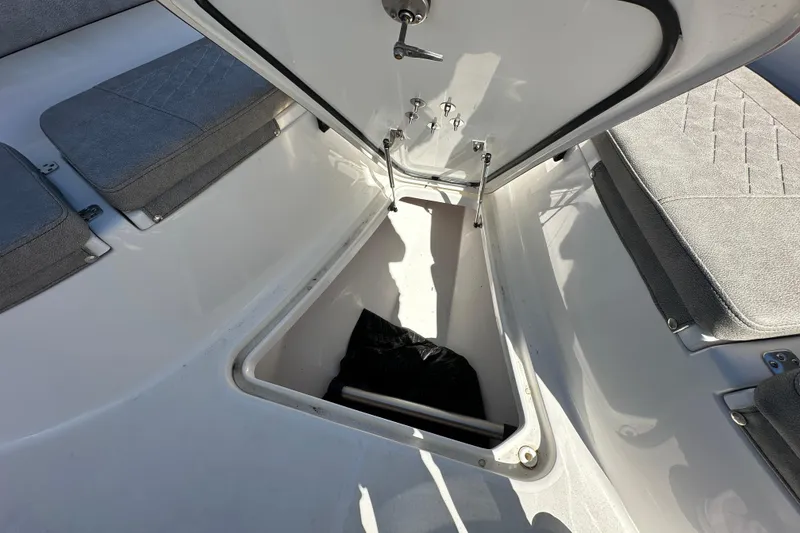 Slide: The Image of 2023 Sea Pro 239 Deep V CC boat storage compartment with open hatch and seating. - 11