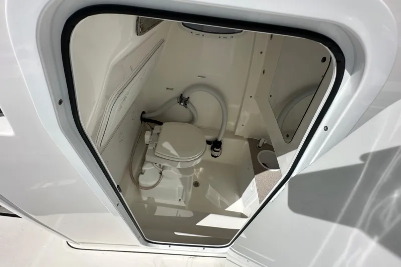 Slide: The Image of 2023 Sea Pro 239 Deep V CC boat interior with compact marine toilet. - 12
