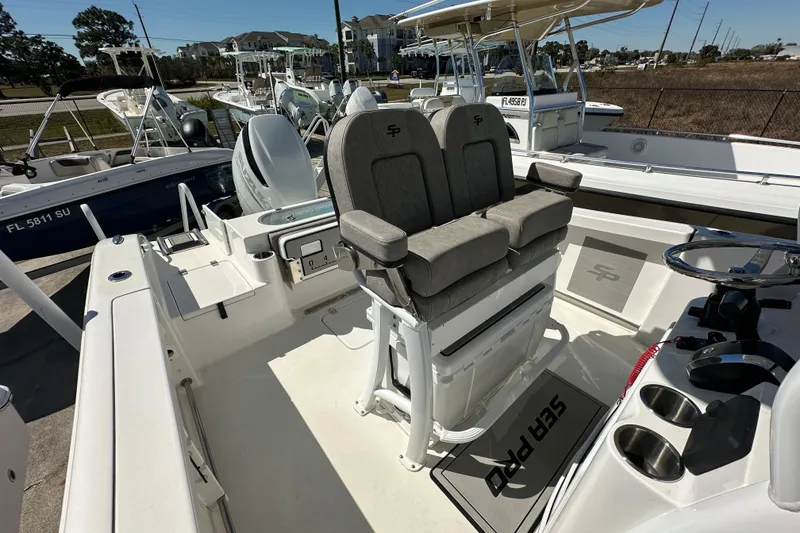 Slide: The Image of 2023 Sea Pro 239 Deep V CC boat interior with dual seats and steering console. - 13