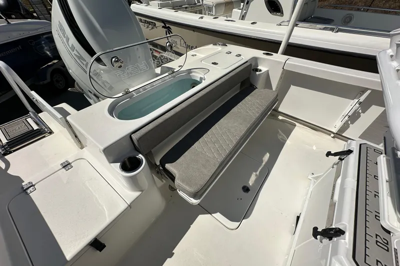 Slide: The Image of 2023 Sea Pro 239 Deep V CC boat interior with seating and storage features. - 15