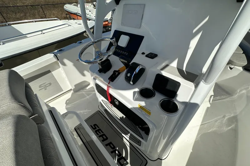 Slide: The Image of 2023 Sea Pro 239 Deep V CC boat console with steering wheel and controls. - 6
