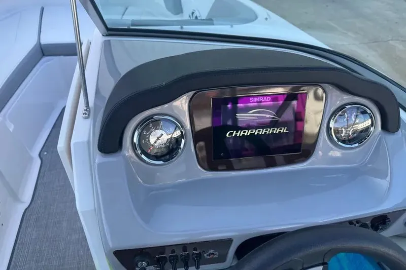 Slide: The Image of 2022 Chapparall 21 SSi boat dashboard with Simrad display and gauges. - 7