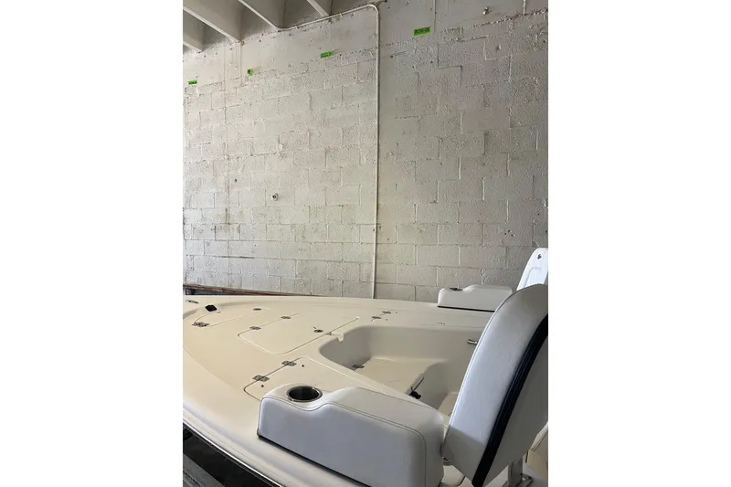 Slide: The Image of 2024 Sea Pro 230 Bay boat interior, featuring seating and storage compartments. - 2