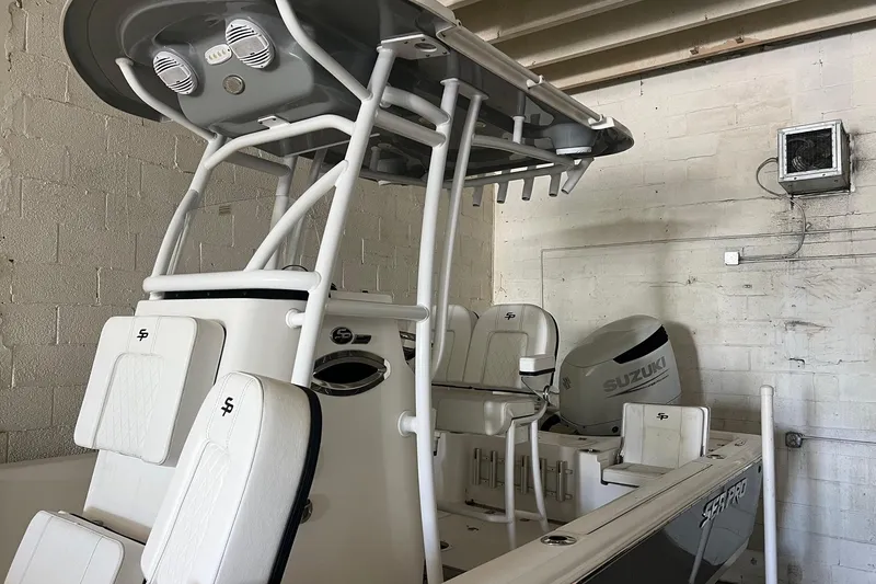 Slide: The Image of 2024 Sea Pro 230 Bay boat with Suzuki engine in a garage setting. - 3